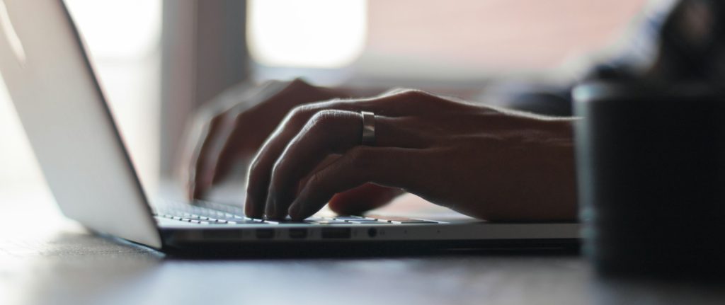 close up of fingers typing on a keyboard