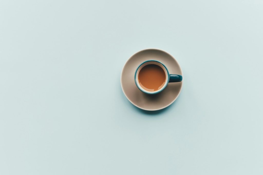 a cup of coffee from above, in the minimalist style