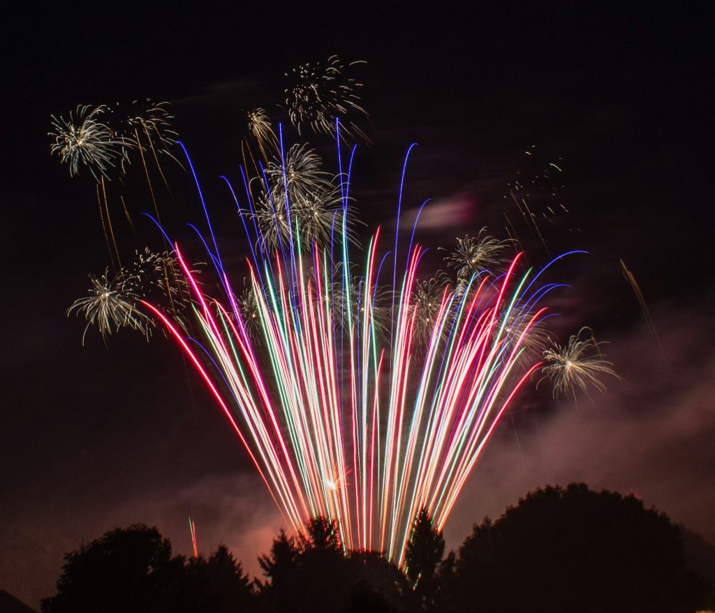 fireworks streaking into the night sky and exploding