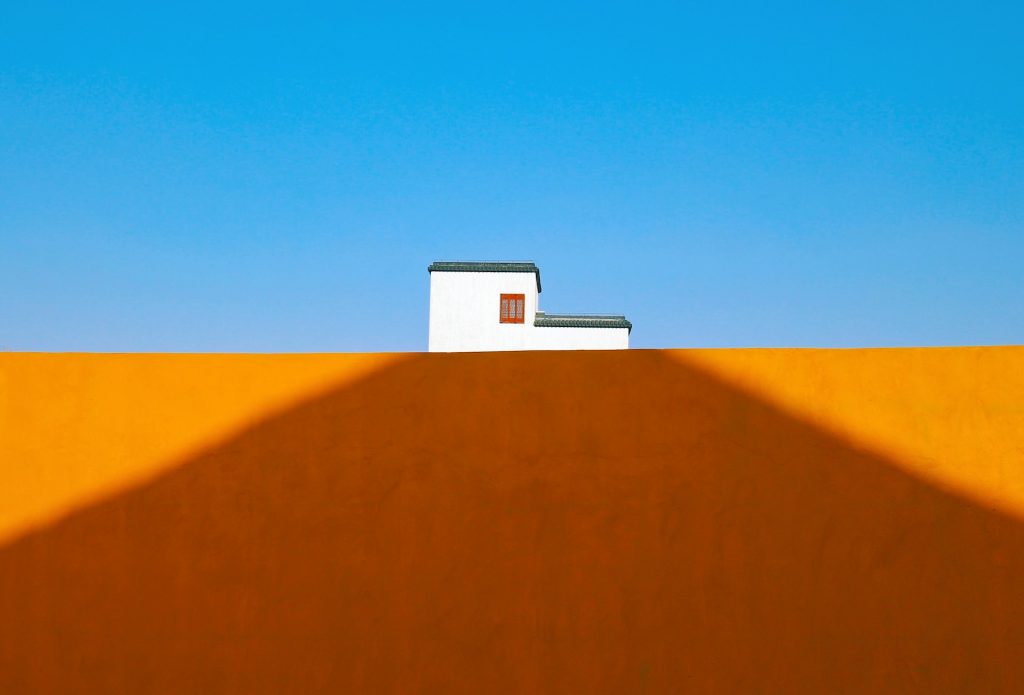 white house in the desert with blue sky