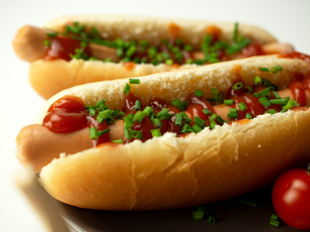 close up of two hot dogs with relish