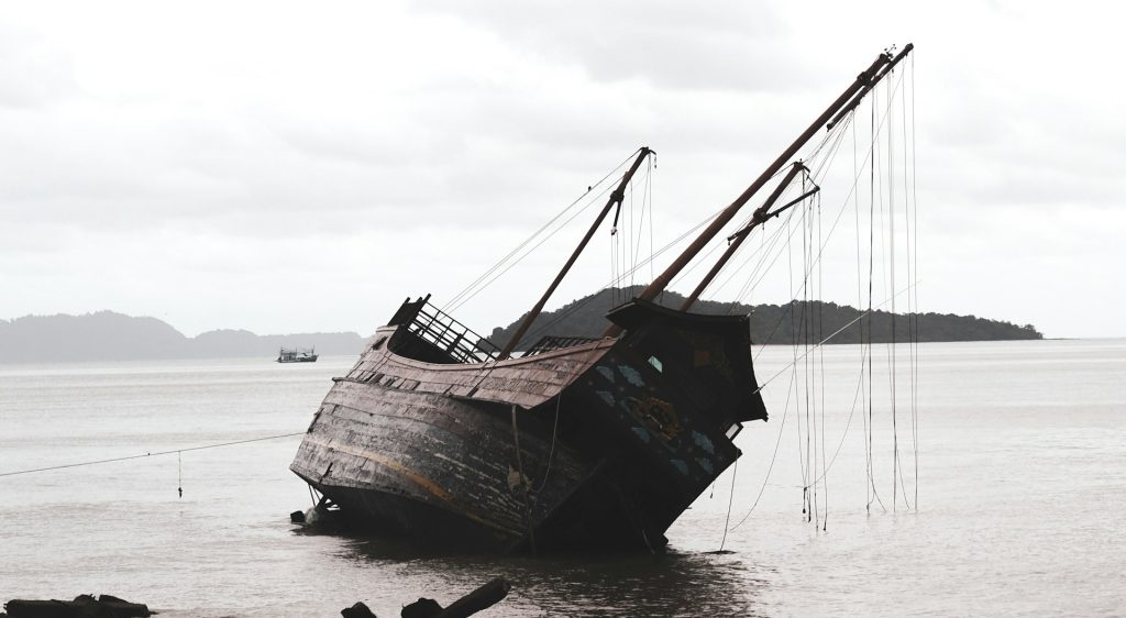 Wooden ship wrecked on the beach