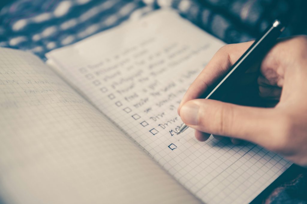 close up of hand writing a checklist