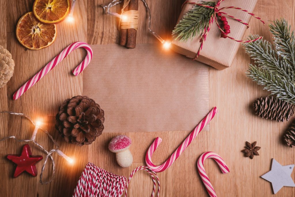 candy canes next to a package and pine cone